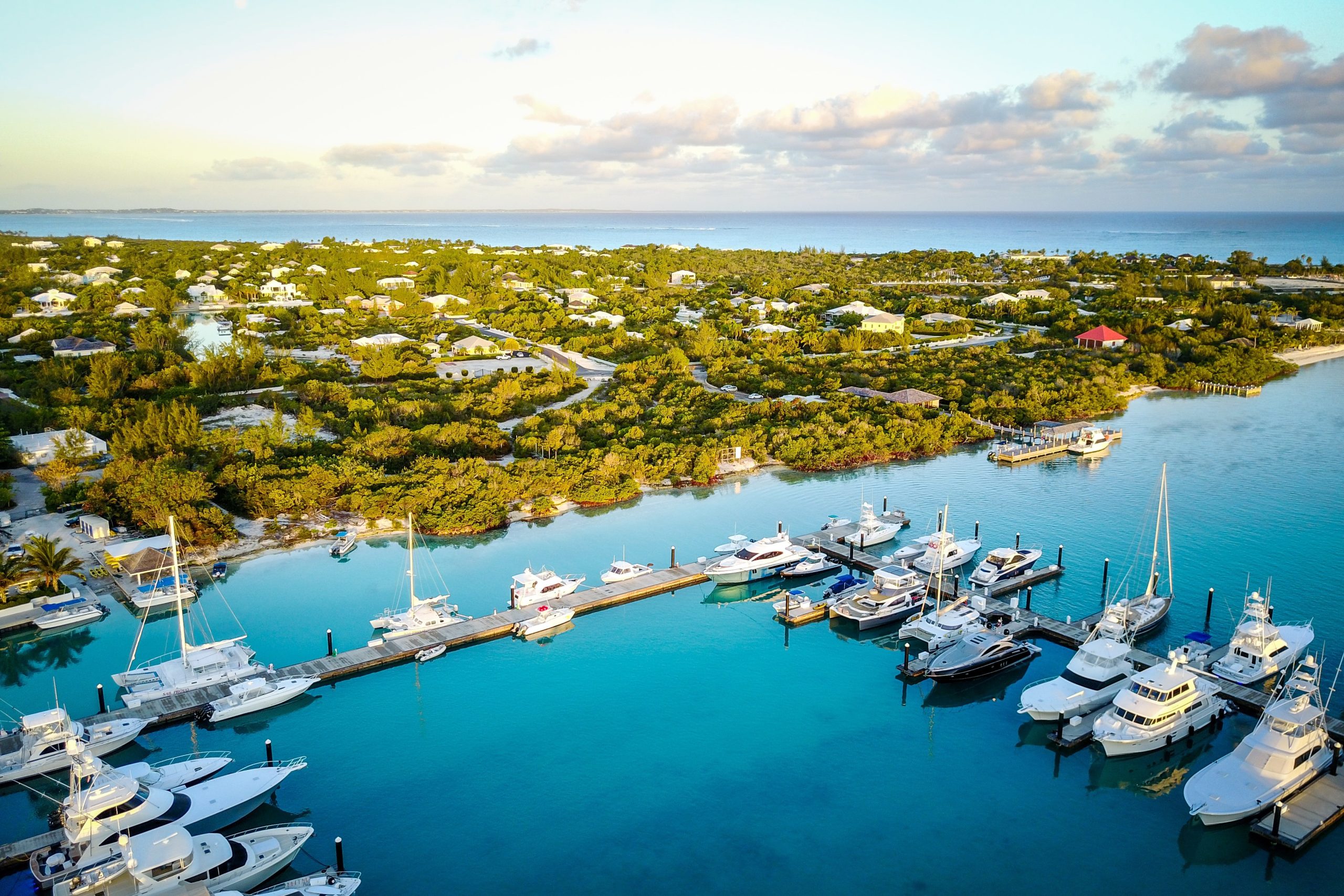 The marina at sunrise with luxury yachts in the Turks and Caicos islands